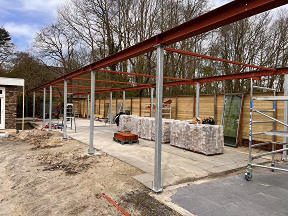 Stalen overkapping voor tuin met buitenhuis
